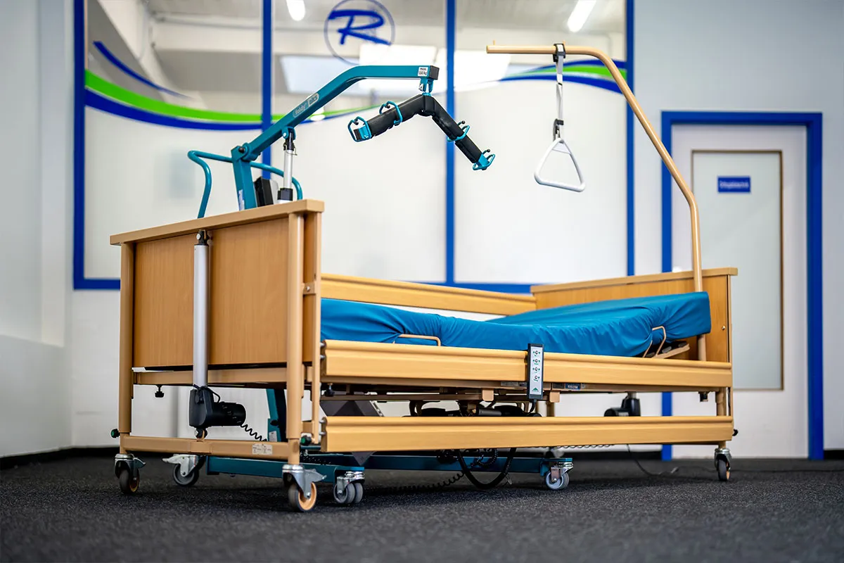 Höhenverstellbares Pflegebett mit Aufrichthilfe in der Ausstellung